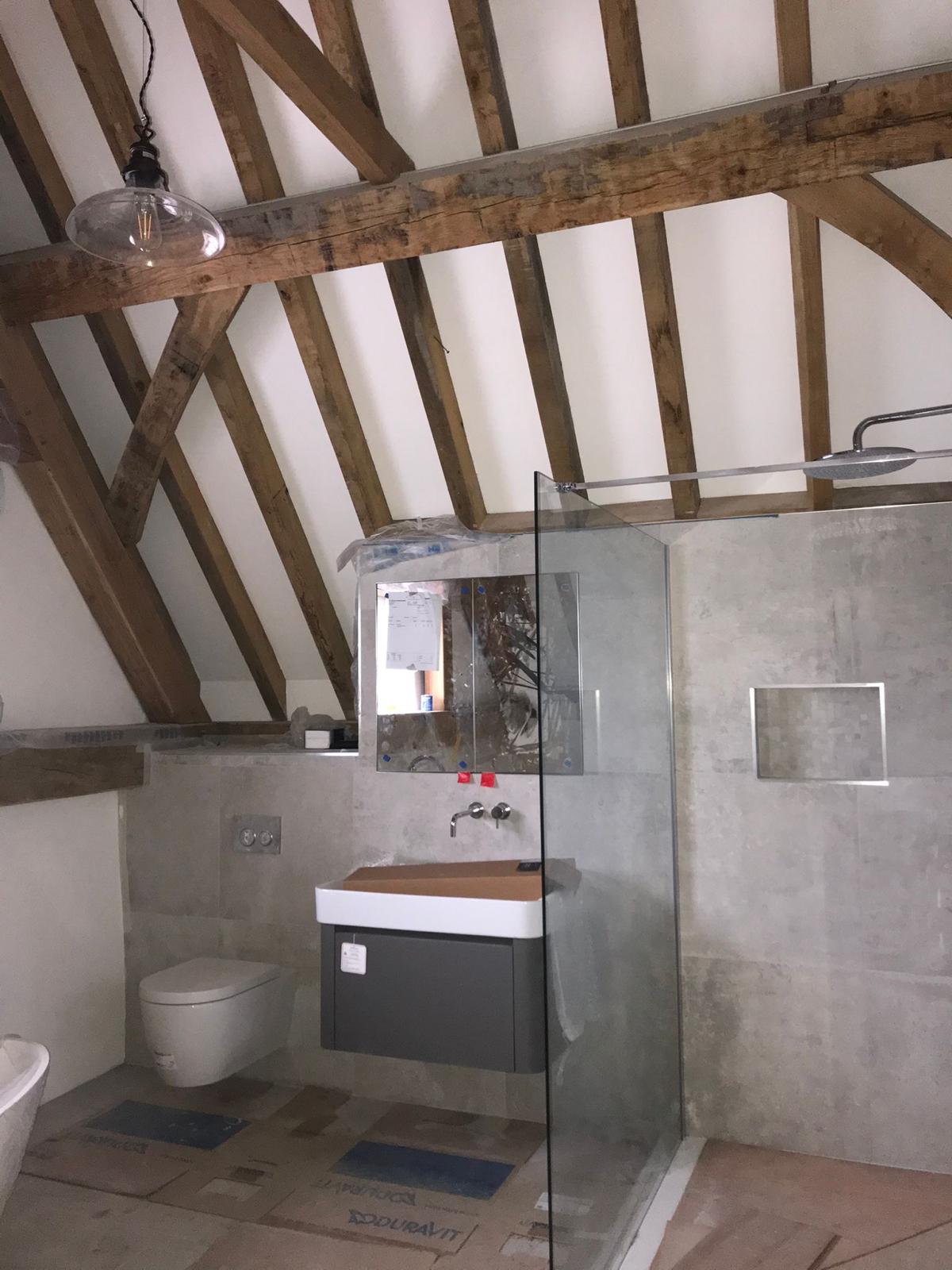 Bathroom with walk-in shower and exposed beams