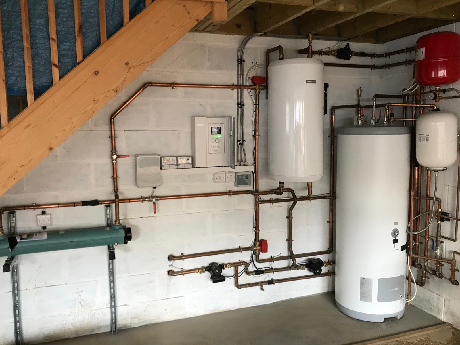 Full plant room with heat pump controls and cylinders