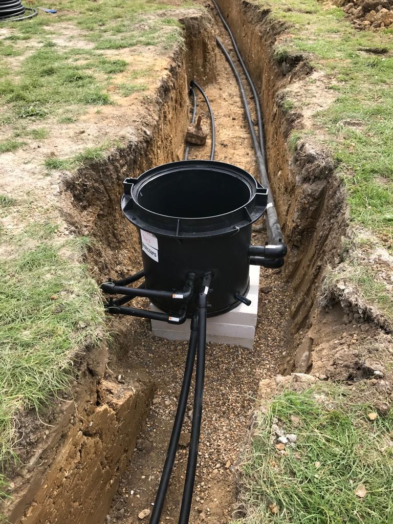 Ground source manifold pit